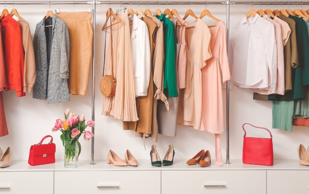 An image showing a women's professional wardrobe full of colorful dresses, shoes, etc.